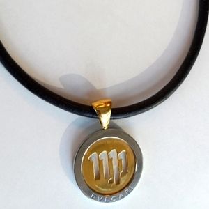 Bvlgari 18 Karat Gold Steel Virgo Tondo Pendant on Leather Cord.
